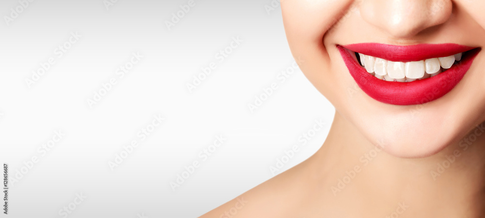 Pretty woman smile against a grey background with copyspace Pretty woman smile against a grey background with copyspace