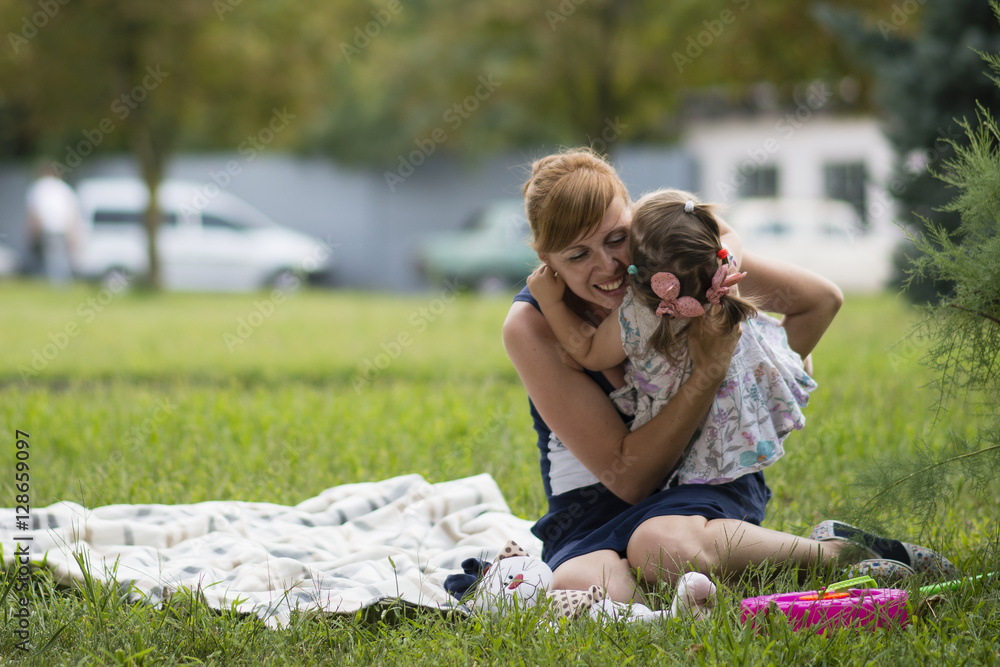 Mother and little daughter playing at a picnic Mother and little daughter playing at a picnic