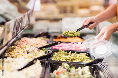Close up view of hands picking prepared meals