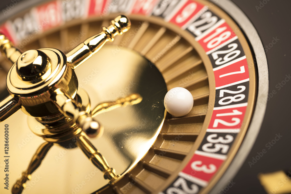 Casino theme. Golden roulette wheel closeup. Casino theme. Golden roulette wheel closeup.