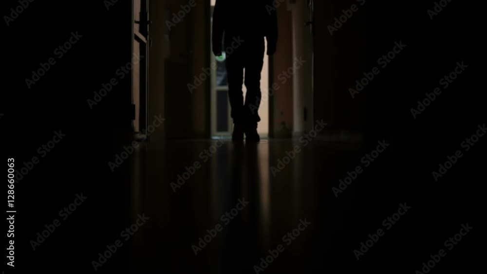 a man walks down the dark corridor a man walks down the dark corridor