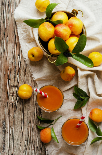 Fototapeta Naklejka Na Ścianę i Meble -  Fresh apricot juice in glass on wooden table, selective focus