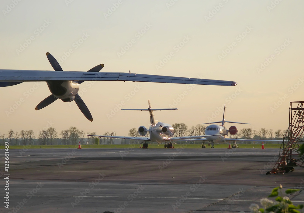 Airplane wing with propeller and two private jet aircraft Airplane wing with propeller and two private jet aircraft