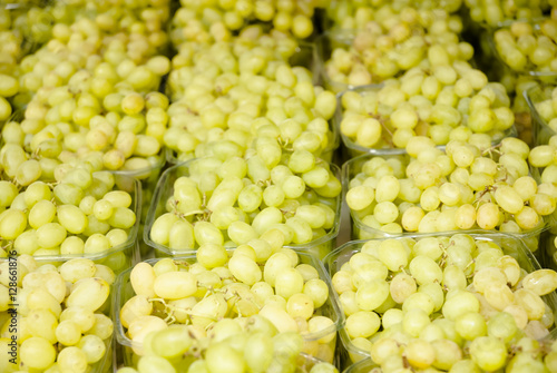Grapes. Bunches of green grapes. Grapes on a tray agriculture market. (Selective focus)