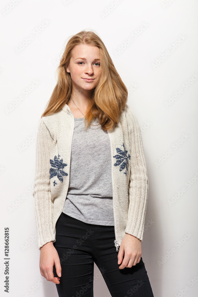 Human face expressions and emotions. Young adorable redhead woman in cozy shirt hands behind head with gorgeous red hair having fun against white studio wall Human face expressions and emotions. Young adorable redhead woman in cozy shirt hands behind head with gorgeous red hair having fun against white studio wall