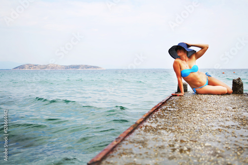 Woman in blue bikini enjoying beach and summer sunny day