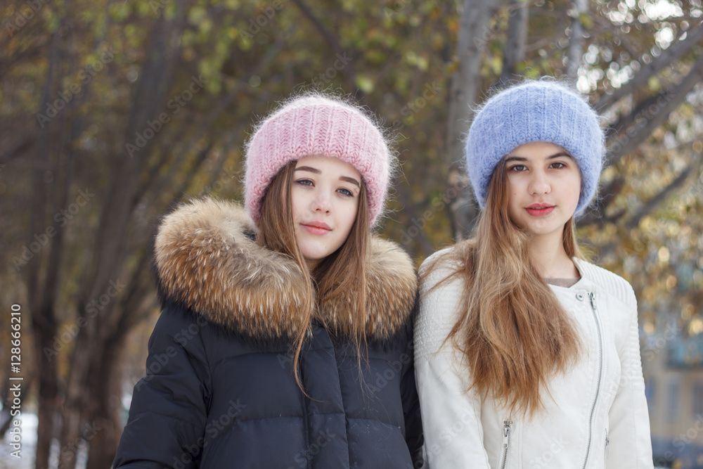 Fototapeta premium Beautiful girl on the nature in the winter outside in winter hat
