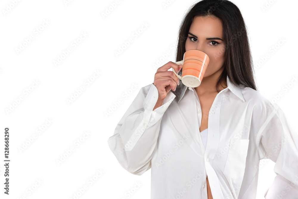 pretty smiling brunette in a white men's shirt holding cup of coffee pretty smiling brunette in a white men's shirt holding cup of coffee