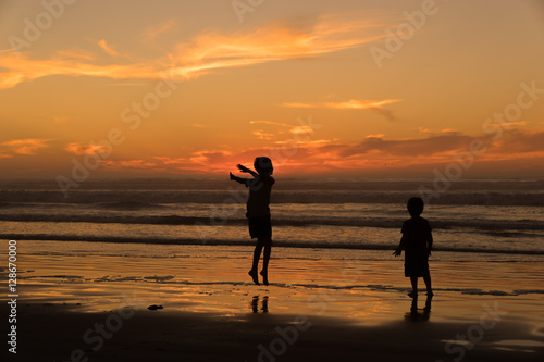 Children Playing in the Surf at Sunset, Pismo Beach California