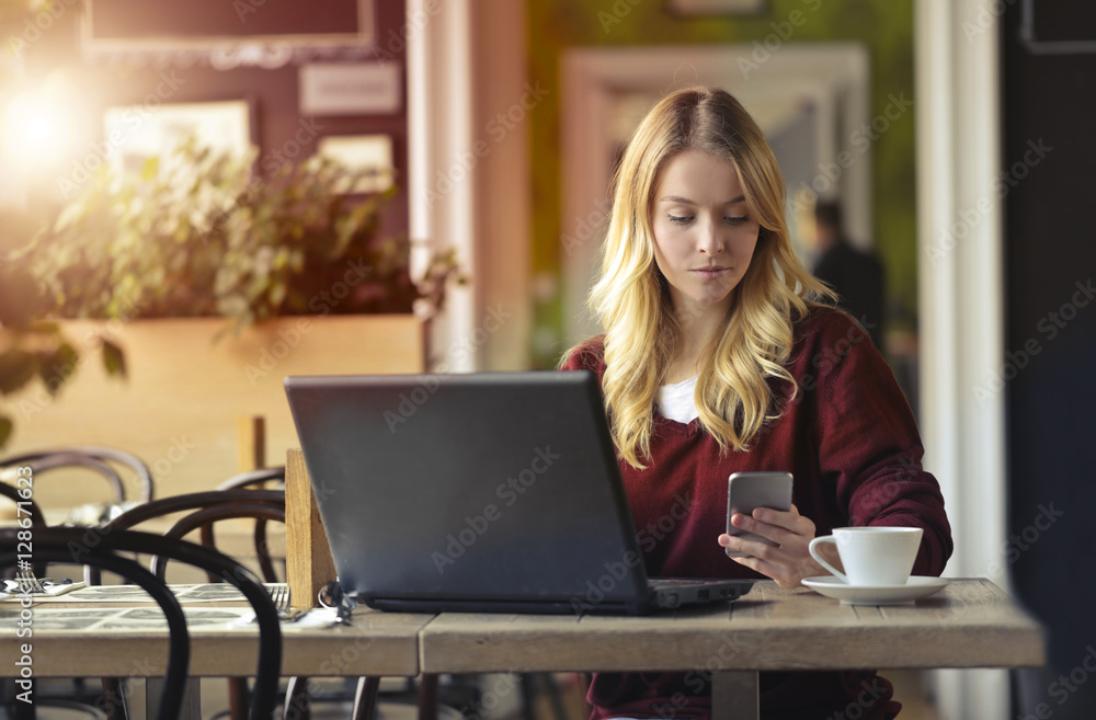 Girl using with laptop and smartphone Girl using with laptop and smartphone
