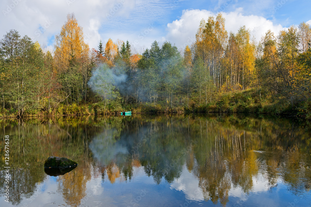 Idyllic autumn landscape with forest lake.