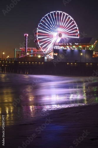 Santa Monica Beach Ferris wheel at night lit with the American Flag
