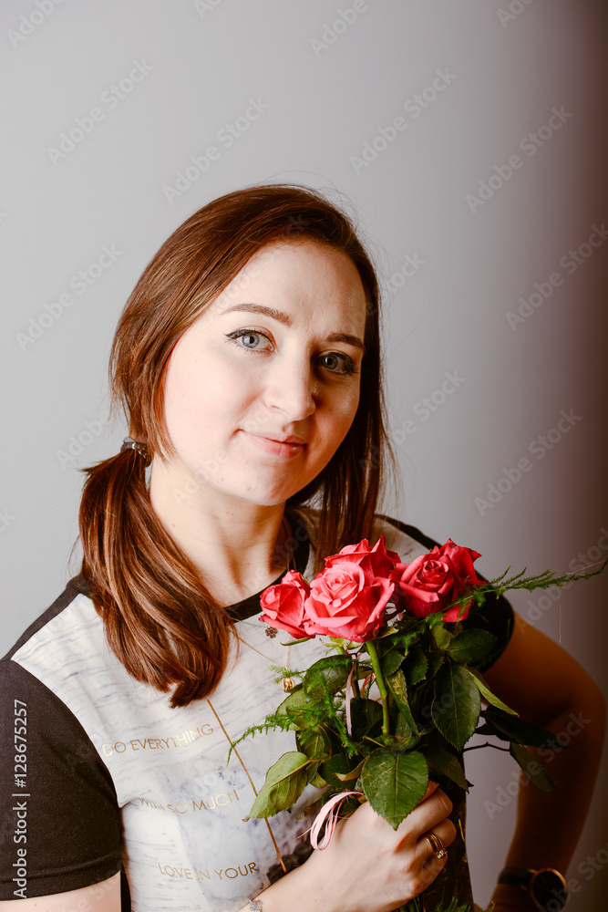 portrait of young charming girl with a bouquet of roses portrait of young charming girl with a bouquet of roses