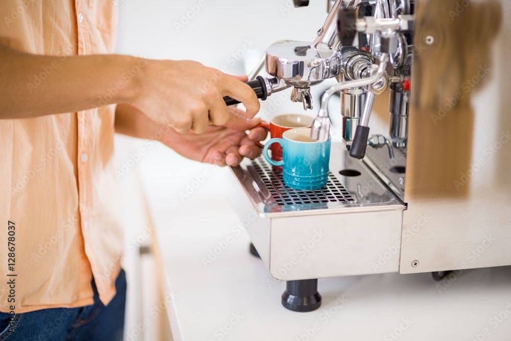 Man preparing coffee from coffeemaker