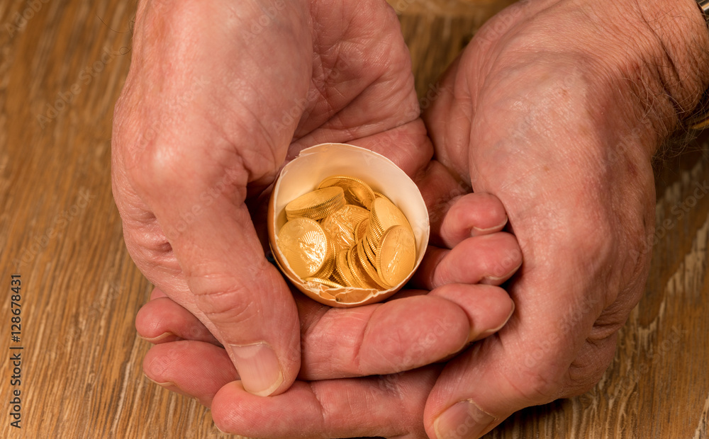 Pure gold coins in egg shell illustrating nest egg Pure gold coins in egg shell illustrating nest egg