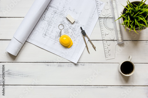 engineering tools on wooden table with drawings apartments top view