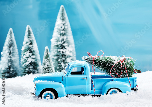 Old blue vintage toy truck with Christmas tree