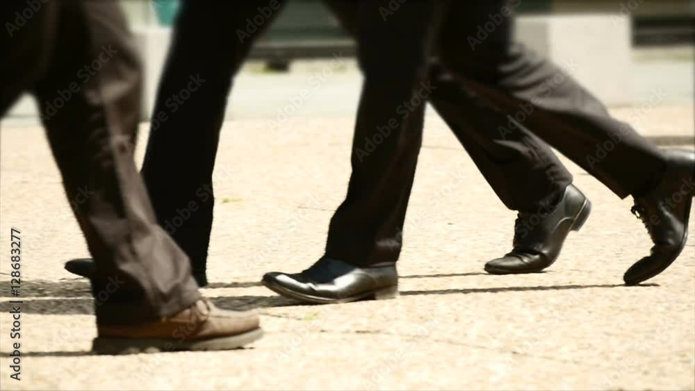 people walking synchronized together. close up of walking legs feet. business people background. people walking synchronized together. close up of walking legs feet. business people background.
