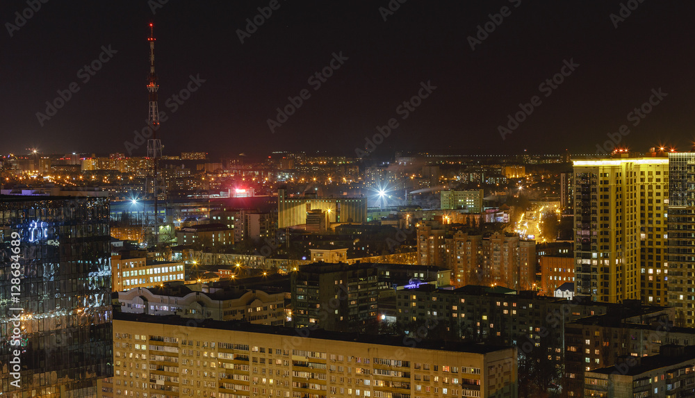 Scenic aerial cityscape at night with illuminated modern architecture. Voronezh,