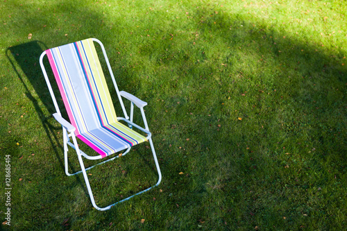 garden chair on green lawn background