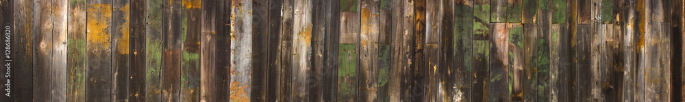 Texture wooden fence with horizontal yellow boards and faded pai