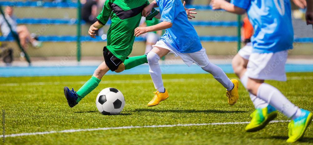 Running Soccer Football Players. Footballers Kicking Football Match game. Young Soccer Players Running After the Ball. Soccer Stadium in the Background Running Soccer Football Players. Footballers Kicking Football Match game. Young Soccer Players Running After the Ball. Soccer Stadium in the Background