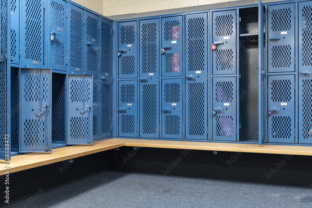Stockfoto Blue metal cage lockers in a locker room with some doors open Stockfoto Blue metal cage lockers in a locker room with some doors open