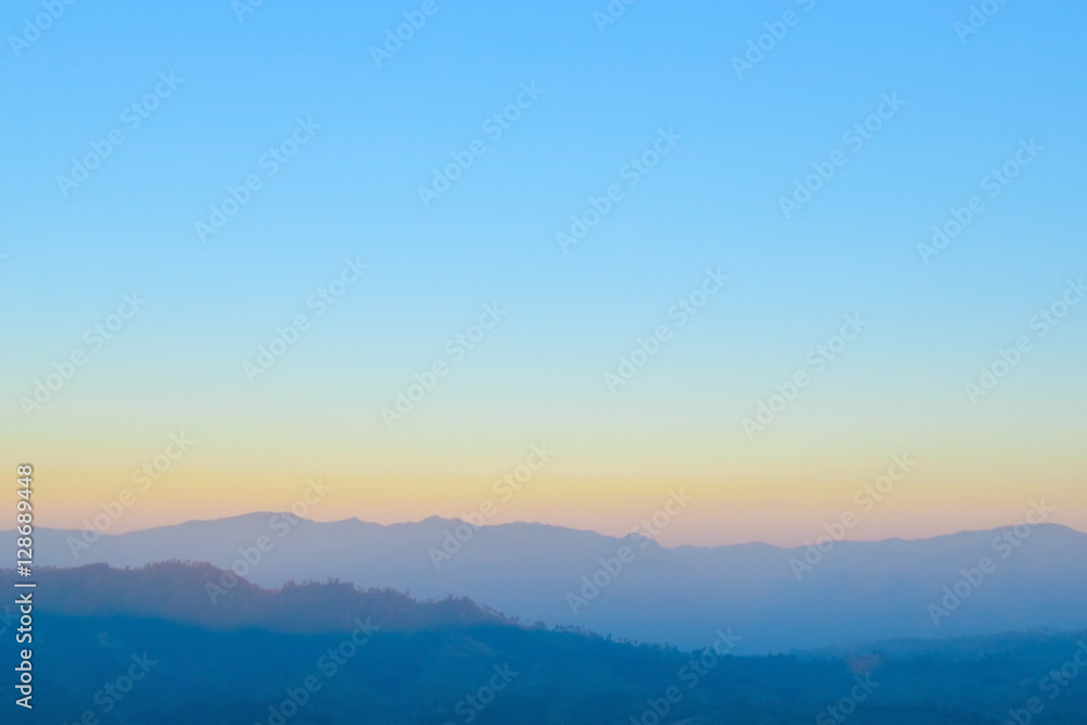 Blurred sunrise orange sky with mountain ,fresh morning nature background