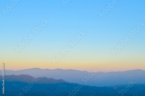 Blurred sunrise orange sky with mountain ,fresh morning nature background