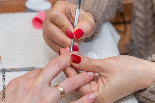 woman doing manicure in beauty salon close-up