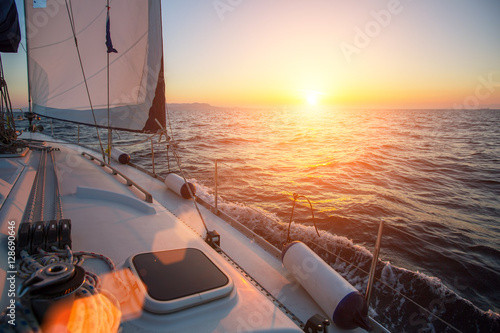 Sailing ship yachts in the open Sea during fantastic sunset. Luxury boats..