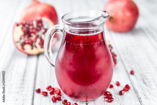 Wallpaper Mural Portion of Pomegranate juice on wooden background (selective foc Torontodigital.ca