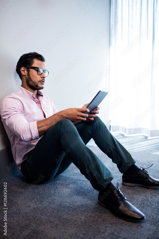 Serious businessman using tablet computer 