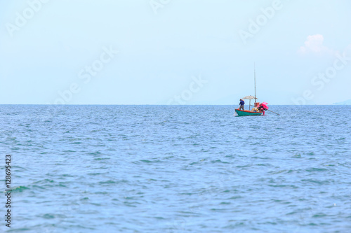 fishing boat and fisherman at sea or ocean water and blue sky background for copy space.