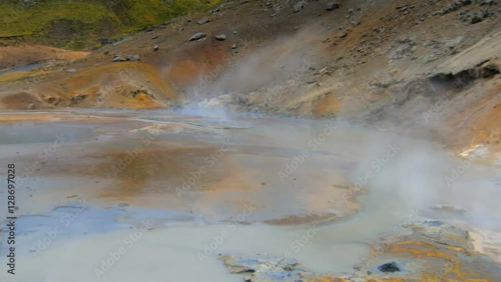 panorama of geothermal area Krysuvik in Iceland with bright blue hot mud, white steam is over area panorama of geothermal area Krysuvik in Iceland with bright blue hot mud, white steam is over area