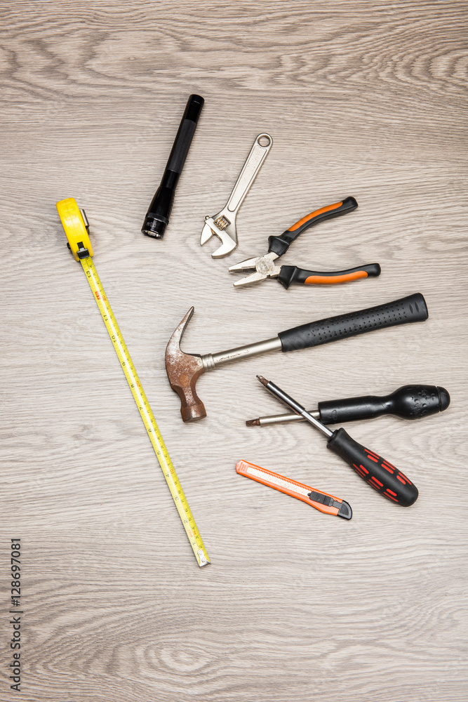 The repair tools is placed on the wooden table. The repair tools is placed on the wooden table.