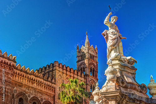 Sculpture in front of Palermo Cathedral church against blue sky, Sicily, Italy photo