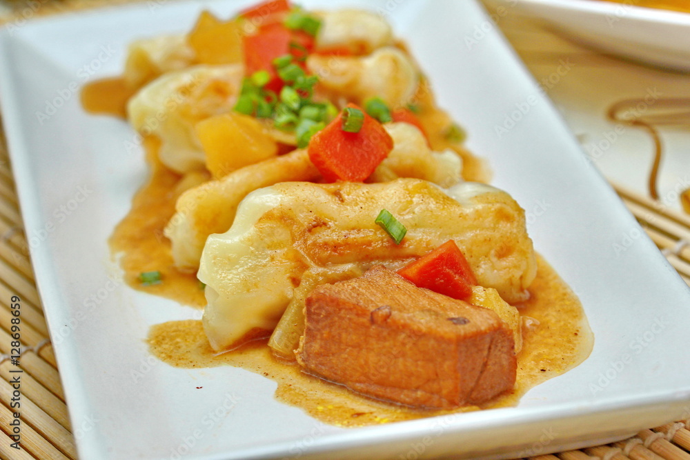 Close up steamed stuffing flour wrap pork topped yellow curry. Close up steamed stuffing flour wrap pork topped yellow curry.
