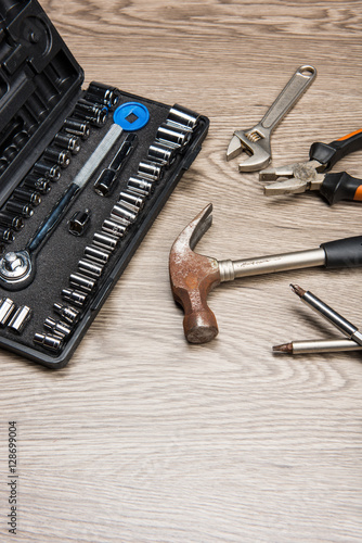 The repair tools is placed on the wooden table.