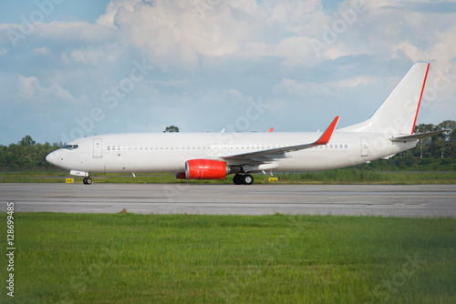 white passenger jet plane on runway at the airport on a sunny da