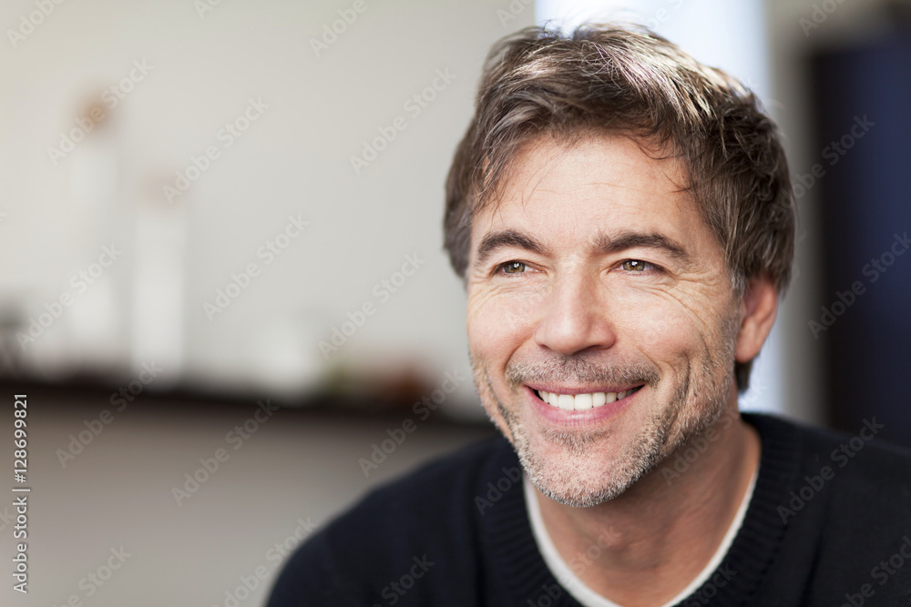 Fototapeta premium Portrait Of A Mature Man Smiling And Looking Away. Home.