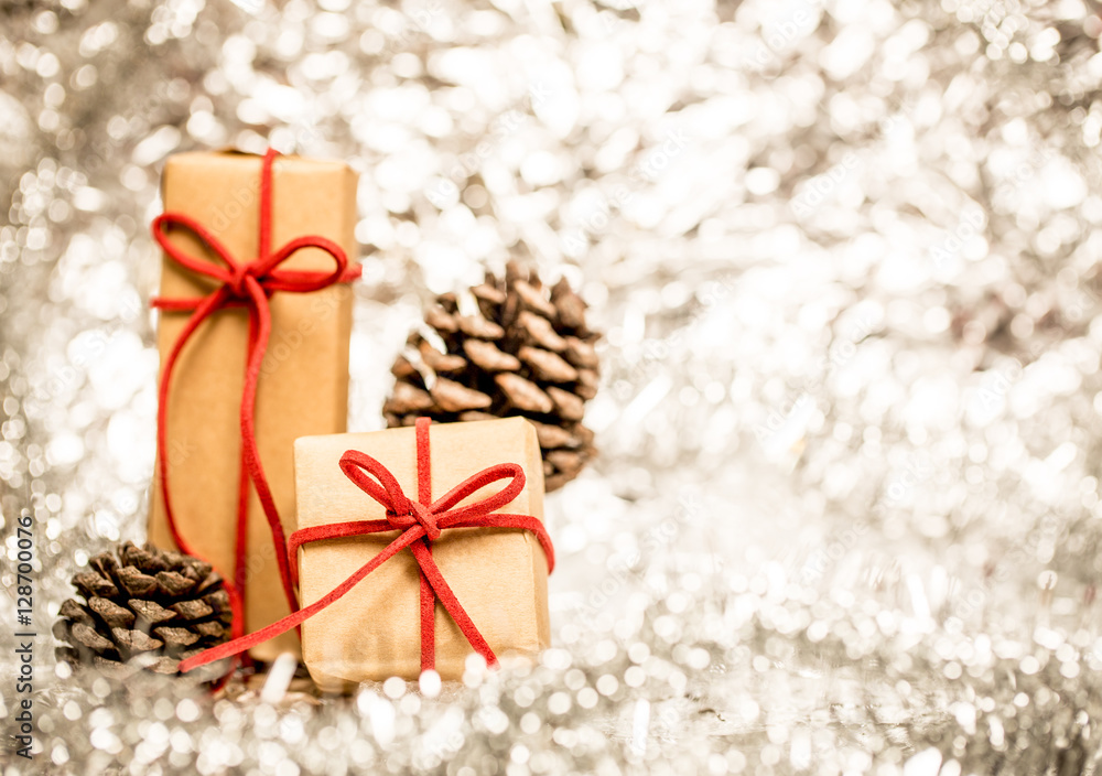 Christmas background with decorative gift and pine cones. Christmas background with decorative gift and pine cones.