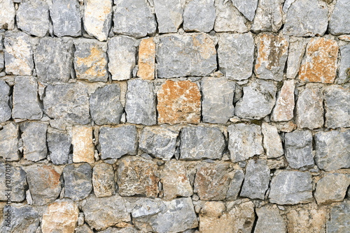 Gray and brown wall with stone masonry  background  texture