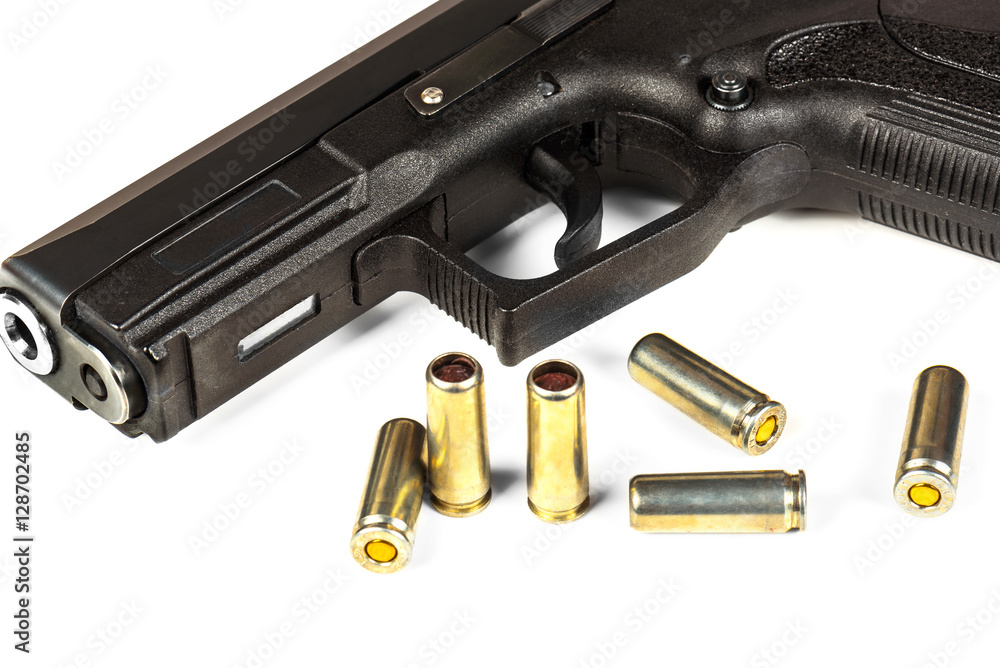 The black gun and cartridges to him on a white background close up.