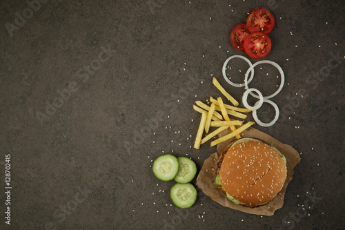 Junk food unhealthy food. Pork or beef burger with french fries,