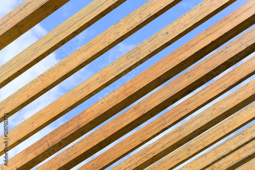 Construction of wooden planks on the background of blue sky
