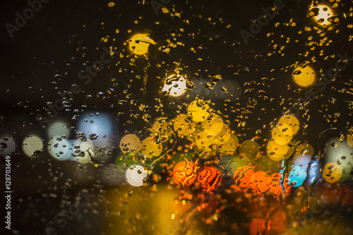 Wet the window with the background of the night city traffic view.