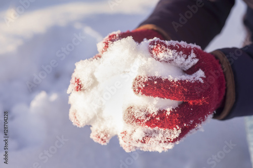 Female shows hands with snowy gloves