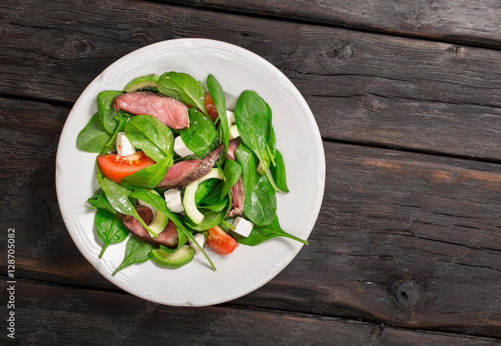 Salad plate with grilled meat, spinach, avocado and feta cheese Salad plate with grilled meat, spinach, avocado and feta cheese