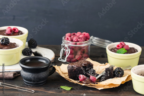 Small chocolate cake with raspberries and cup of coffee